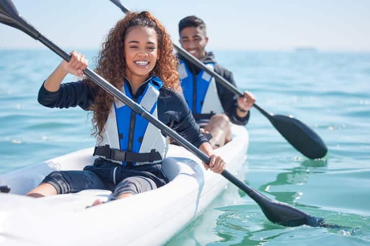 Portrait of a young couple kayaking together.