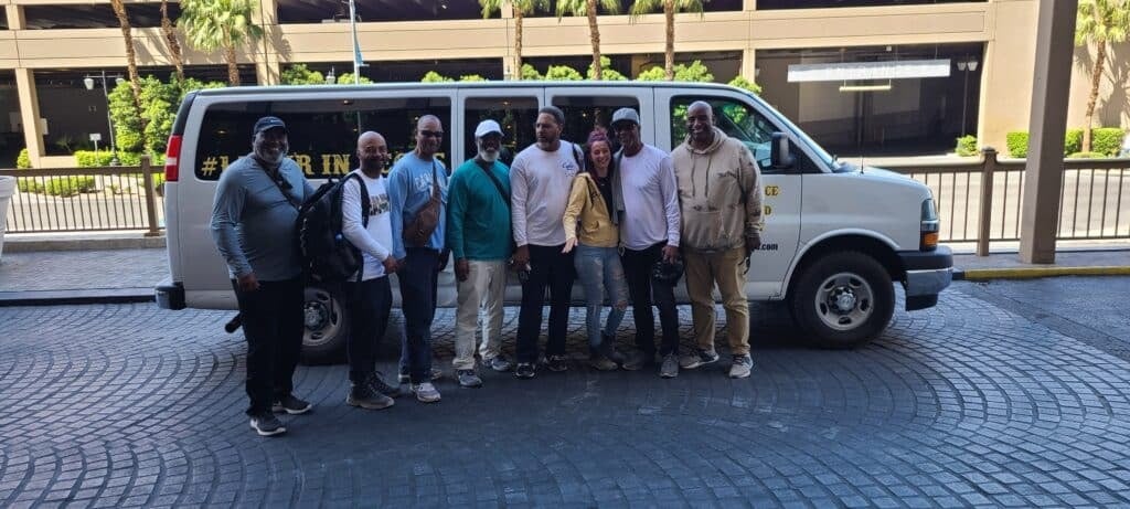 A group photo in front of the transporation van from Awesome Adventures.