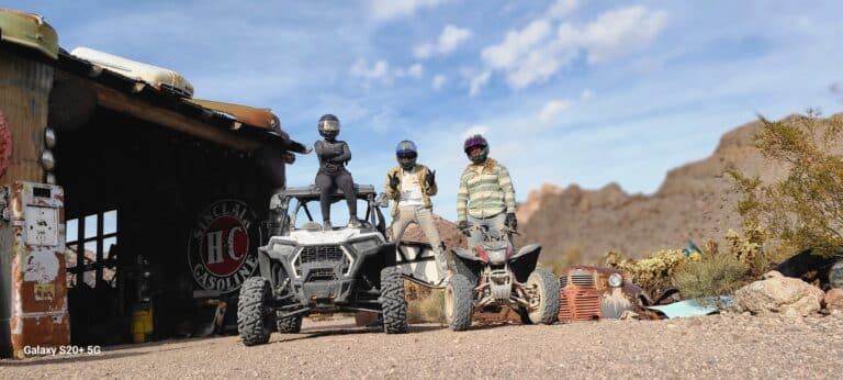 In Nevadas desert near Las Vegas, adventurers enjoy ATV tours and RZR rides. Explore ghost towns by the Colorado River under a blue sky.