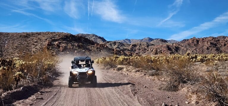 Explore Nevadas rugged beauty near Las Vegas with thrilling RZR off-road rides along the Colorado River amidst majestic mountains.