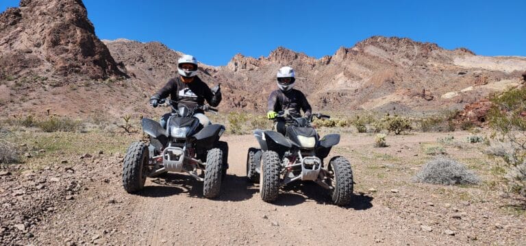 Amid Nevadas rugged desert, adventurers on ATVs explore rocky trails near Las Vegas, embracing thrilling RZR rides and ATV tours.