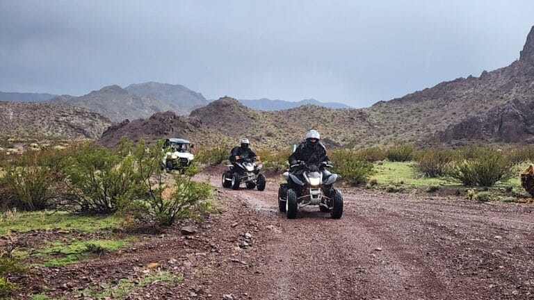 Experience thrilling ATV tours in Nevadas rocky terrain near Las Vegas, with green shrubs and hills like ghost town sightseeing.