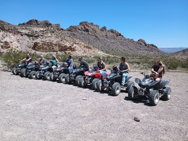A group on quad bikes in Nevadas rocky desert, ready for thrilling RZR off-road adventures near Las Vegas and the Colorado River.