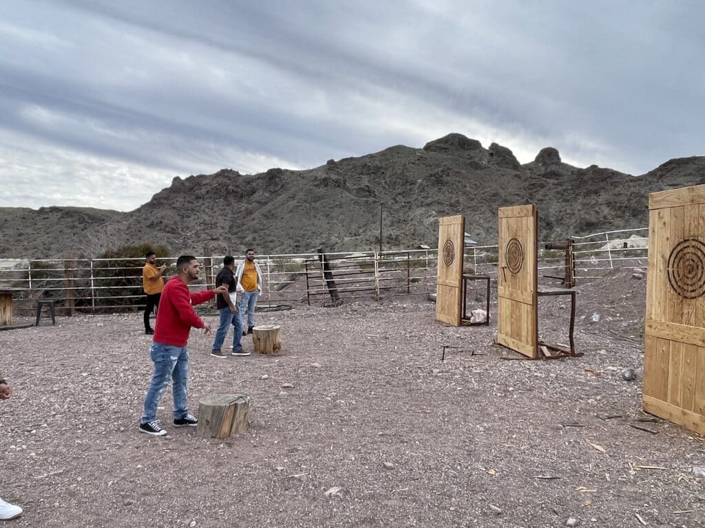 In Nevadas desert landscape, Las Vegas axe throwing thrills like ATV tours, under a cloudy sky near the Colorado River.