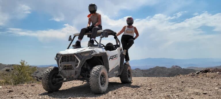 Experience an exhilarating Las Vegas ATV tour in scenic Nevada, with adventurers atop a white off-roader amid rocky desert landscapes.