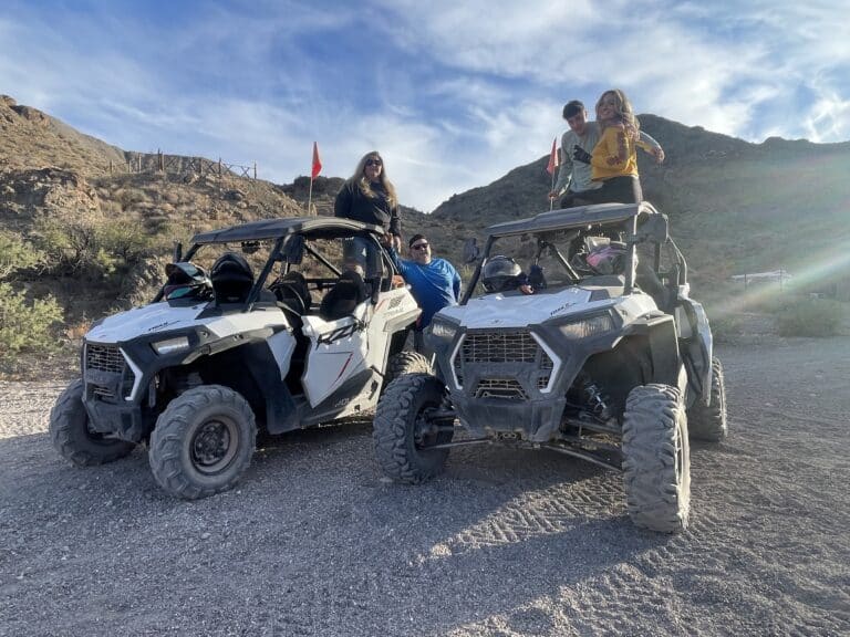 Two off-road vehicles parked on a Nevada gravel path. Perfect day for ATV and RZR tours near Las Vegas with Gold Mine and Ghost Town sights!.