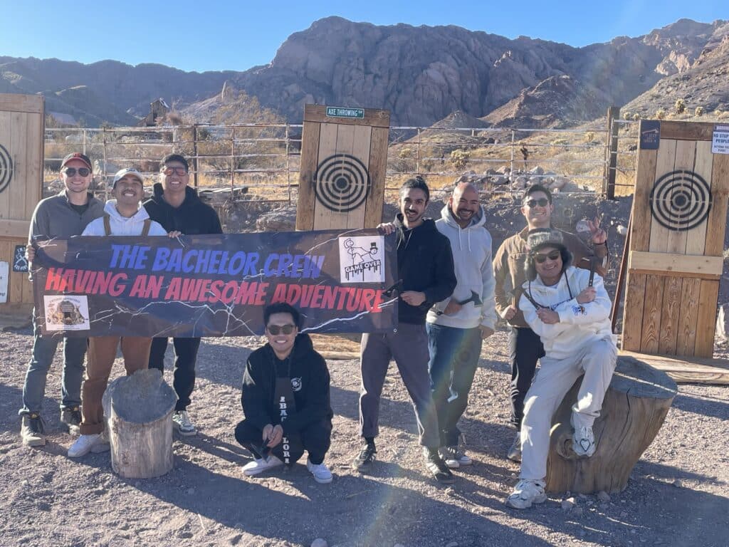 The Bachelor Crew enjoying a thrilling RZR off-road adventure near Las Vegas—posing by targets with stunning Nevada mountains behind!.