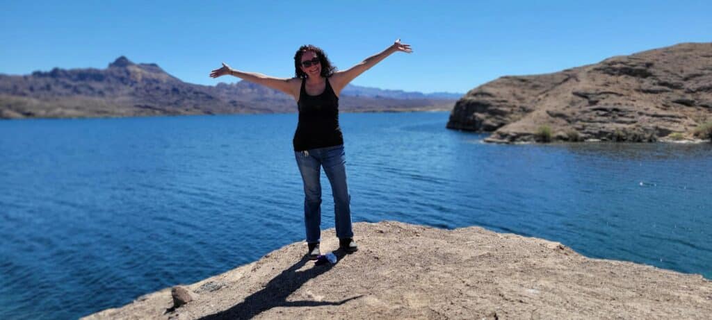 Smiling on a rocky ledge by the Colorado River, Las Vegas. RZR off-road rides with Awesome Adventures capture Nevadas beauty!.