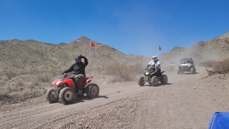 Experience thrilling ATV tours near Las Vegas, Nevada, riding dusty trails by the Colorado River with red-flagged RZRs!.