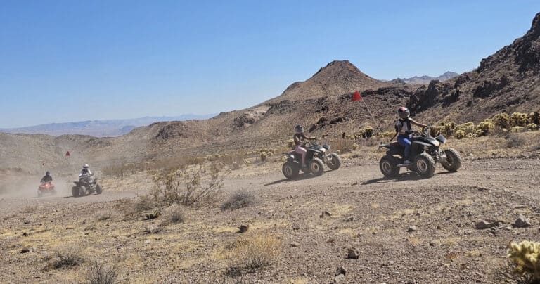 Adventurers enjoy an ATV tour near Las Vegas, riding RZRs through Nevada’s rocky desert trails by the Colorado River.