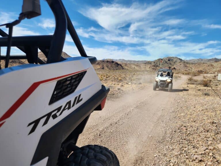 Experience thrilling Las Vegas ATV tours: RZR off-road rides on dusty Nevada desert trails near the Colorado River and scenic rocky hills.