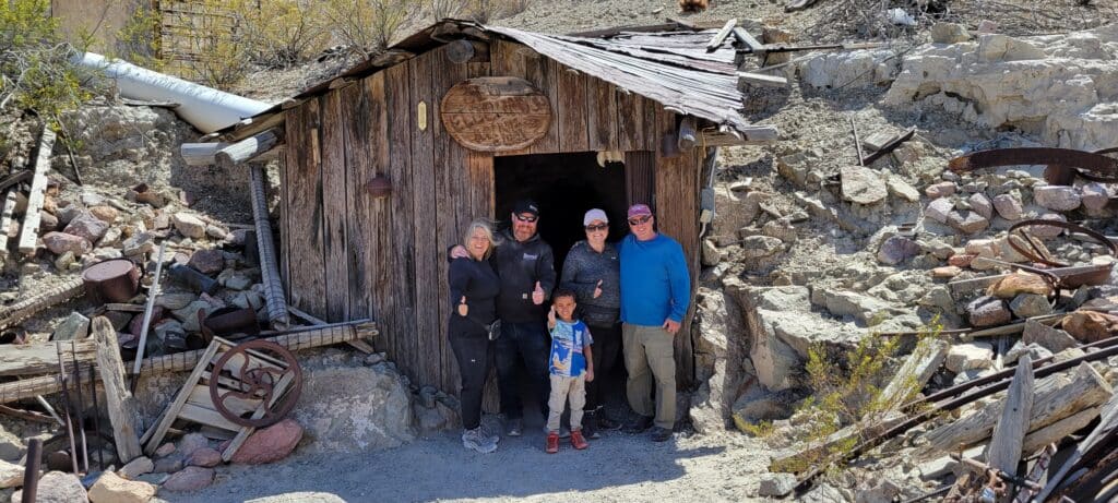 Smiling group gives thumbs up at a Nevada ghost town near Las Vegas after an exciting ATV tour along the Colorado River.