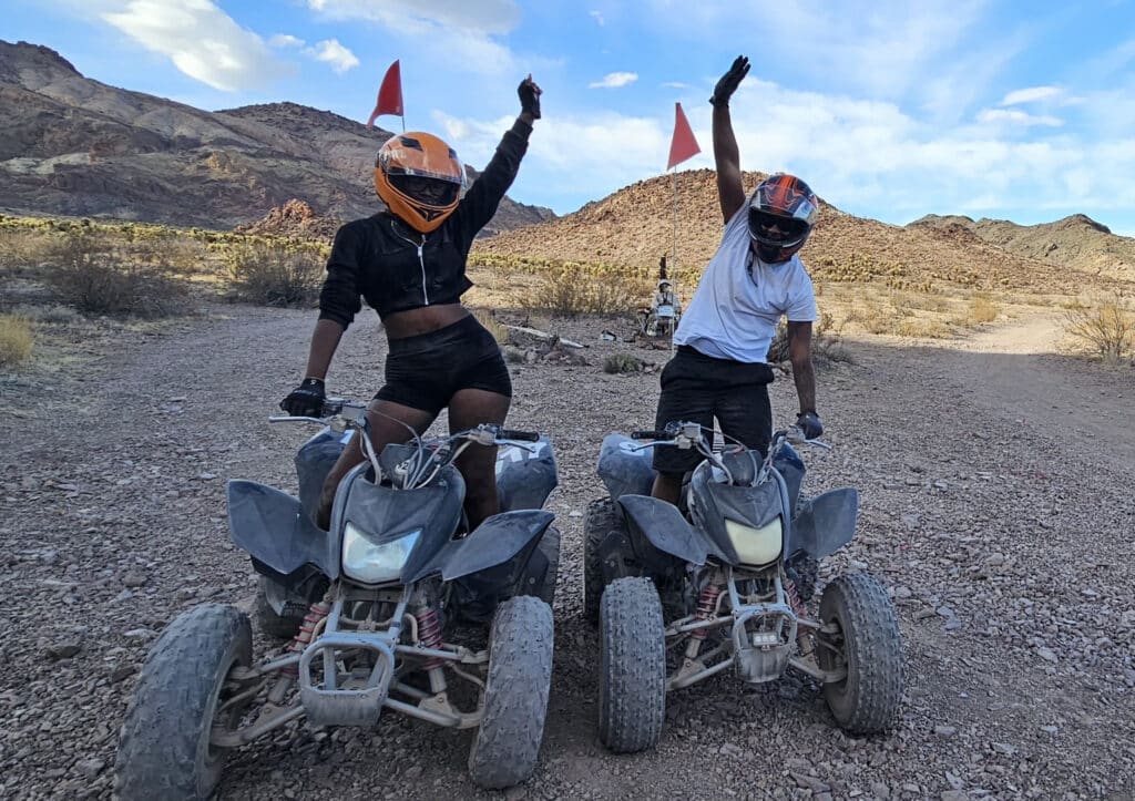 Adventurers on ATVs in Nevadas desert near Las Vegas, enjoying off-road tours with hills and the Colorado River views.