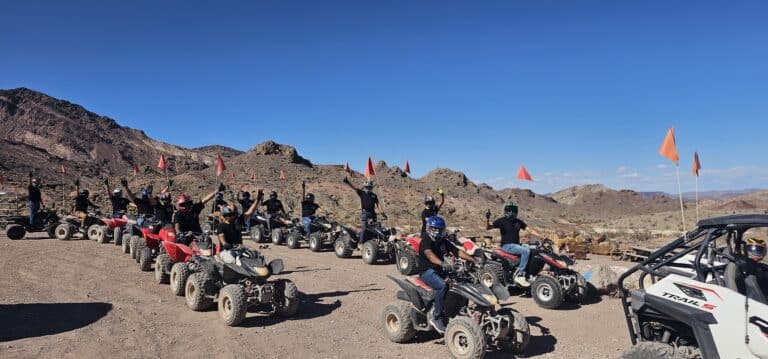 Adventure seekers in helmets line up ATVs & RZRs for an epic Nevada desert tour near Las Vegas and the Colorado River.