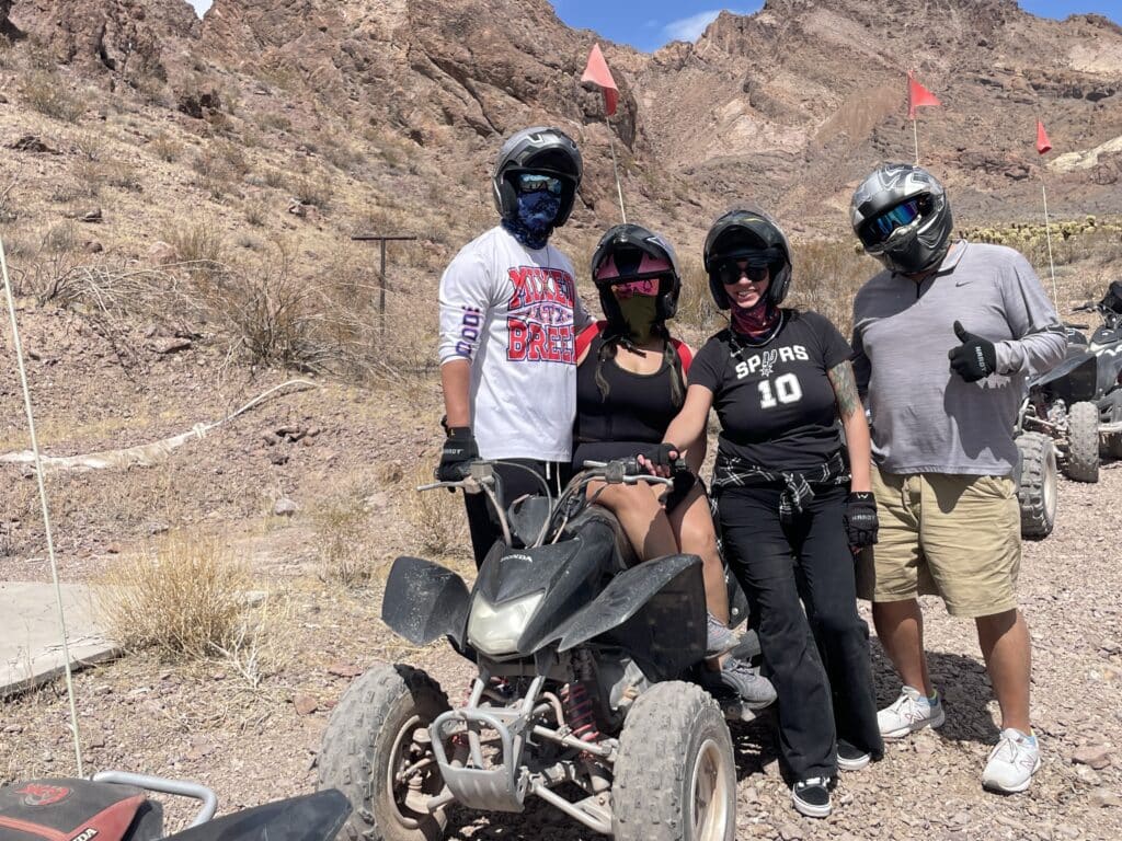 Group enjoying an ATV tour near Las Vegas, Nevada—posing with helmets in the desert by the Colorado River and Ghost Town sites.