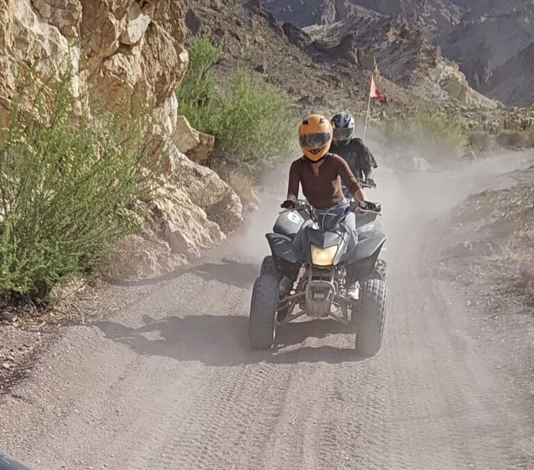 Experience thrilling ATV tours near Las Vegas, riding dusty trails by rocky Nevada cliffs and desert views along the Colorado River.