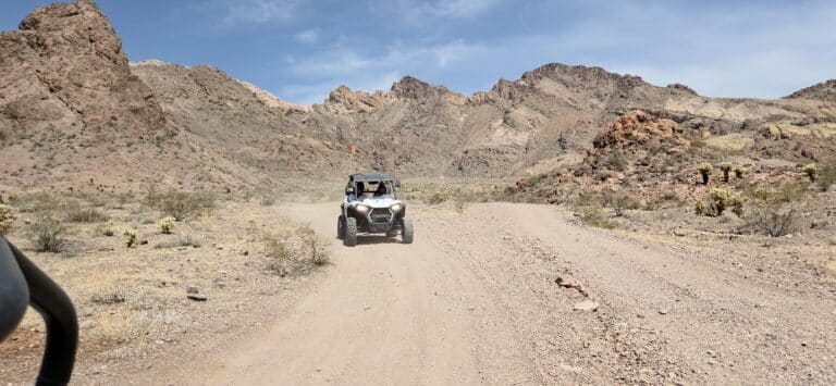 Experience thrilling RZR off-road rides near Las Vegas on dusty Nevada trails by the Colorado River, surrounded by desert mountains.