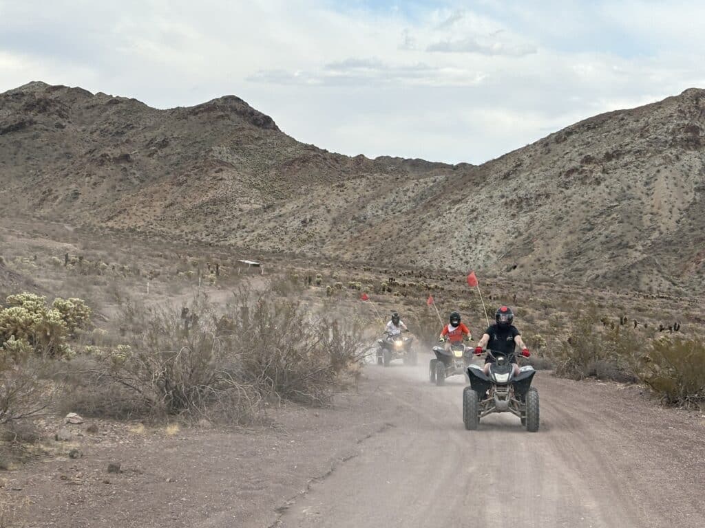 Explore Nevada’s desert near Las Vegas on an ATV tour—ride dusty trails by rocky hills, red flags flying, and Colorado River views.