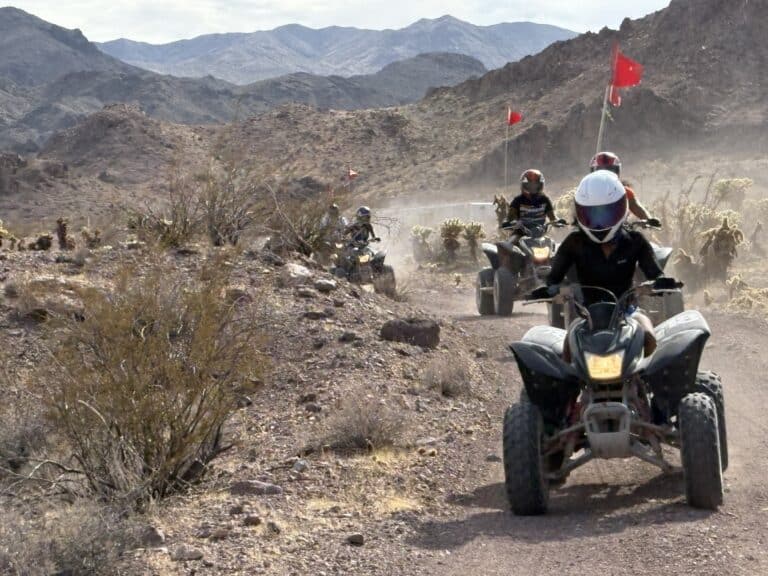 Experience a thrilling ATV tour near Las Vegas, Nevada—ride dusty trails by rocky hills with mountain views and red-flagged ATVs!.
