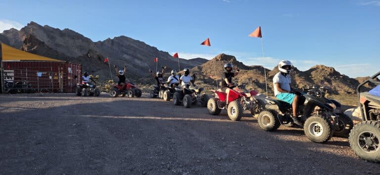 Experience thrilling Las Vegas ATV tours near the Colorado River—ride in a scenic Nevada mountain trail with helmets and orange flags!.
