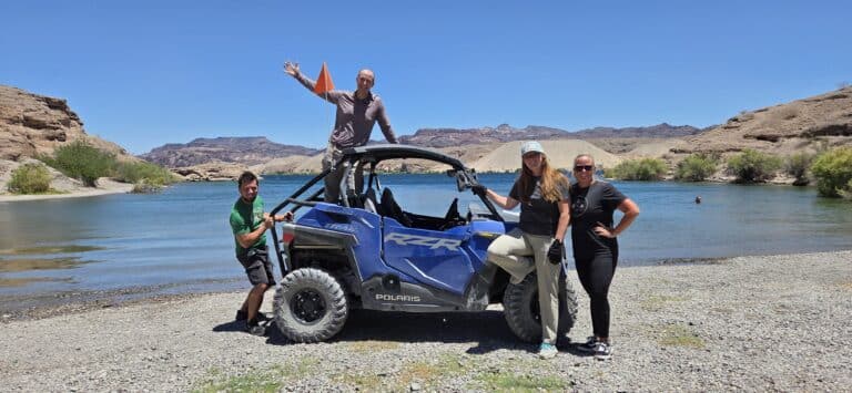 Four friends enjoy a Polaris RZR ATV tour near Las Vegas on the Colorado River, exploring Nevada’s scenic hills and ghost towns.