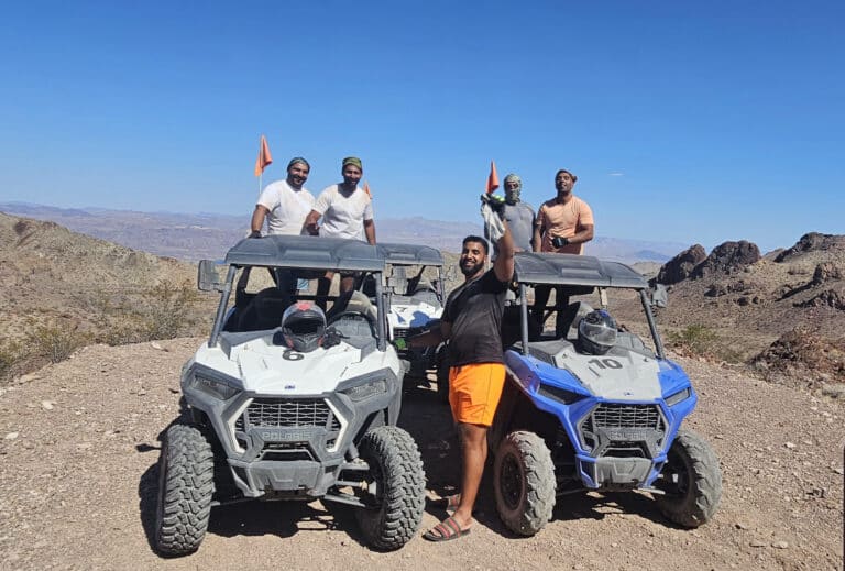 Five friends enjoy a thrilling RZR off-road ride near Las Vegas, Nevada, overlooking the Colorado River and scenic desert views.