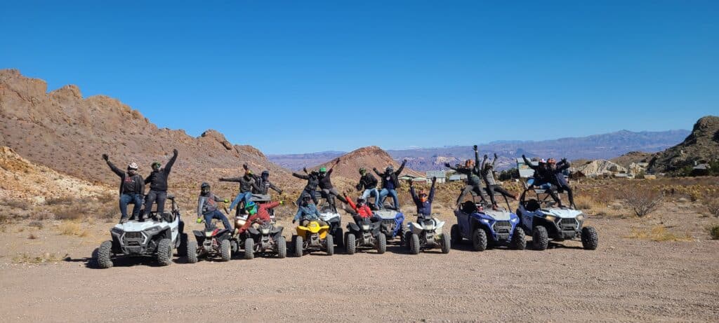 Adventurers on ATVs pose in the Nevada desert near Las Vegas, enjoying thrilling ATV tours and Colorado River views.