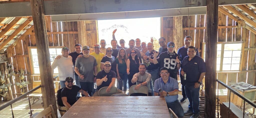 A group celebrates after a thrilling Las Vegas ATV tour in Nevada, posing inside a rustic lodge near the scenic Colorado River.