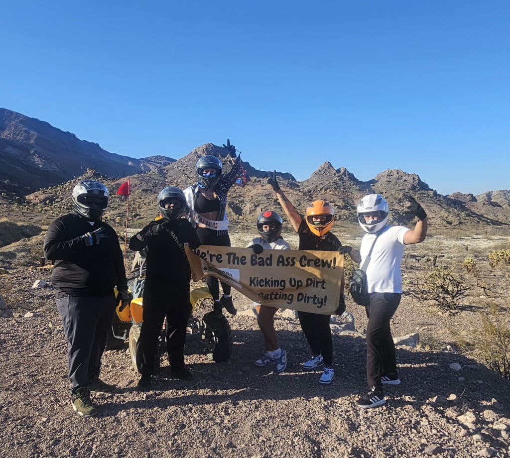Adventurers in Nevada near Las Vegas pose in helmets after a wild ATV and RZR off-road ride by the Colorado River Ghost Town.