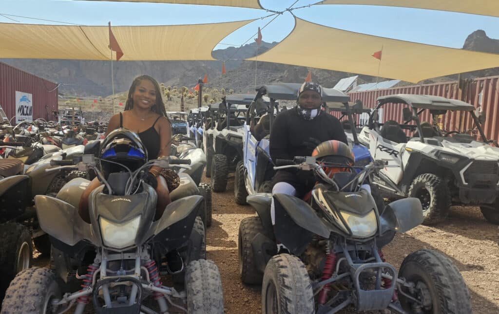 Riders on ATVs in a dusty Nevada landscape near Las Vegas, with mountains in view—perfect for thrilling ATV and RZR tours.
