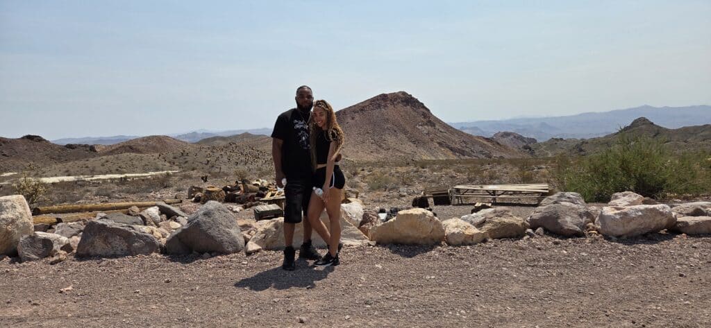 A couple stands on rocky desert terrain near Las Vegas, Nevada, perfect for ATV tours or Colorado River adventures.