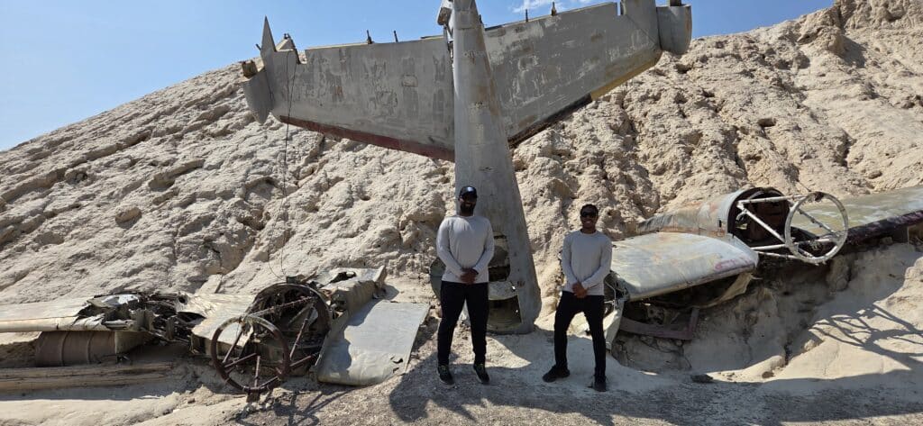 Two explore a plane wreck in Nevada’s desert near the Colorado River—perfect for ATV tours and Las Vegas ghost town adventures.