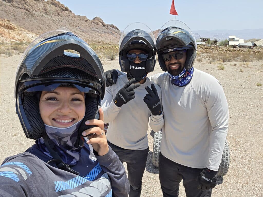 Adventure seekers in helmets pose for a selfie on a Nevada ATV tour near Las Vegas with RZR rides by the Colorado River.