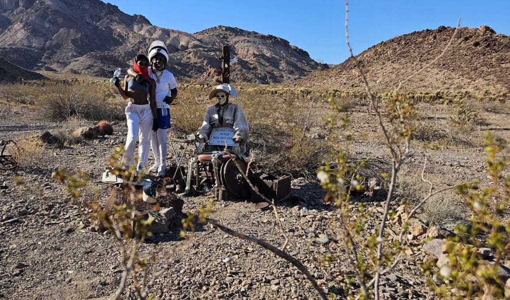 Three miner mannequins in Nevada desert near Las Vegas Ghost Town, with old mining cart—perfect for ATV and RZR off-road tours!.