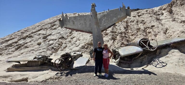 Two explore a weathered airplane wreck in Nevada’s desert near Las Vegas—perfect for ATV tours or RZR off-road adventures!.