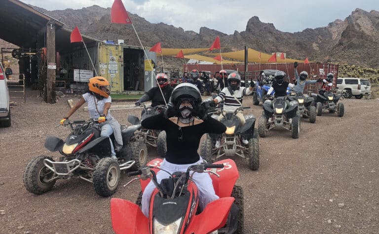 Adventurers in helmets line up on ATVs in Nevada, ready for Las Vegas ATV tours and Colorado River off-road rides.