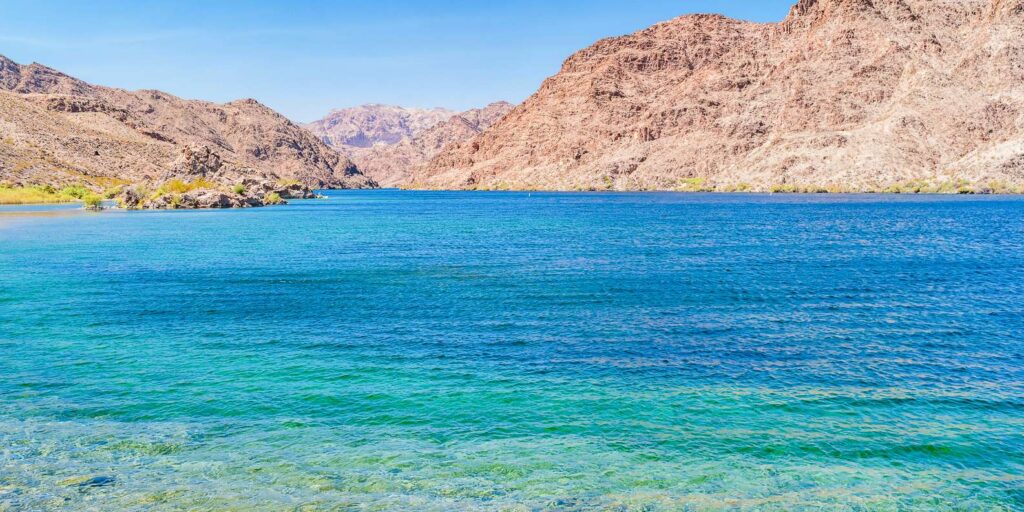 Turquoise waters of the Colorado River near Las Vegas, Nevada, framed by rocky mountains—ideal for ATV tours and RZR adventures.