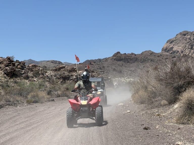 Experience thrilling ATV tours near Las Vegas, Nevada—ride a red quad through desert trails with mountain views by the Colorado River.