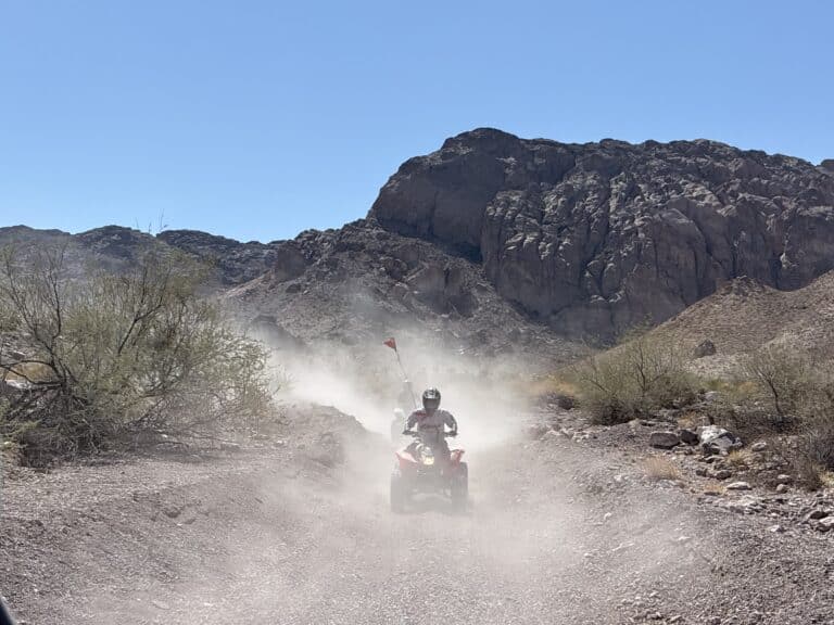 Experience an ATV tour near Las Vegas on dusty desert trails by the Colorado River, with mountain views under Nevada’s clear blue sky.