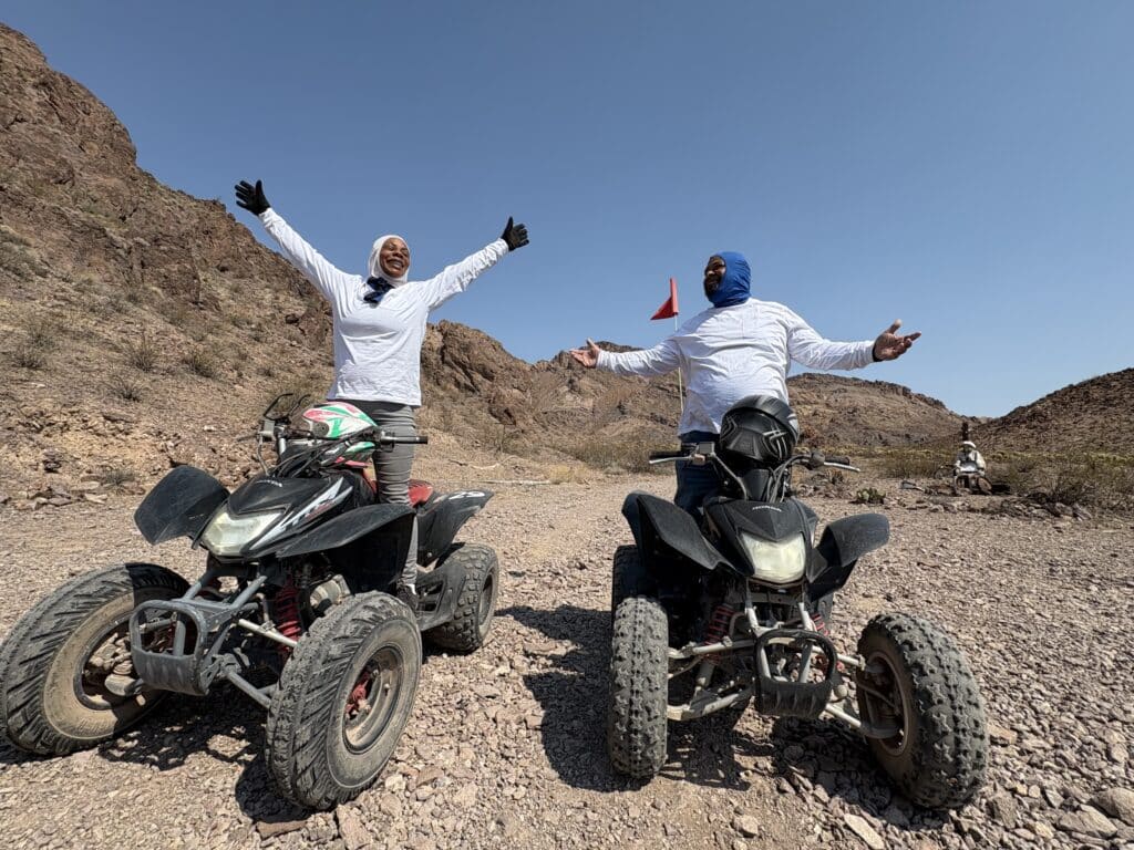 Adventurers in long sleeves enjoy an exciting ATV tour near the Colorado River in Nevada’s rocky desert by Las Vegas.