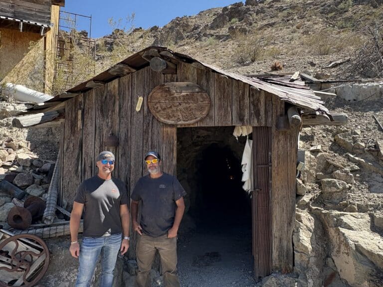 Two men in sunglasses at a rustic Nevada mine near Las Vegas, perfect for ATV tours and Colorado River Ghost Town sightseeing.