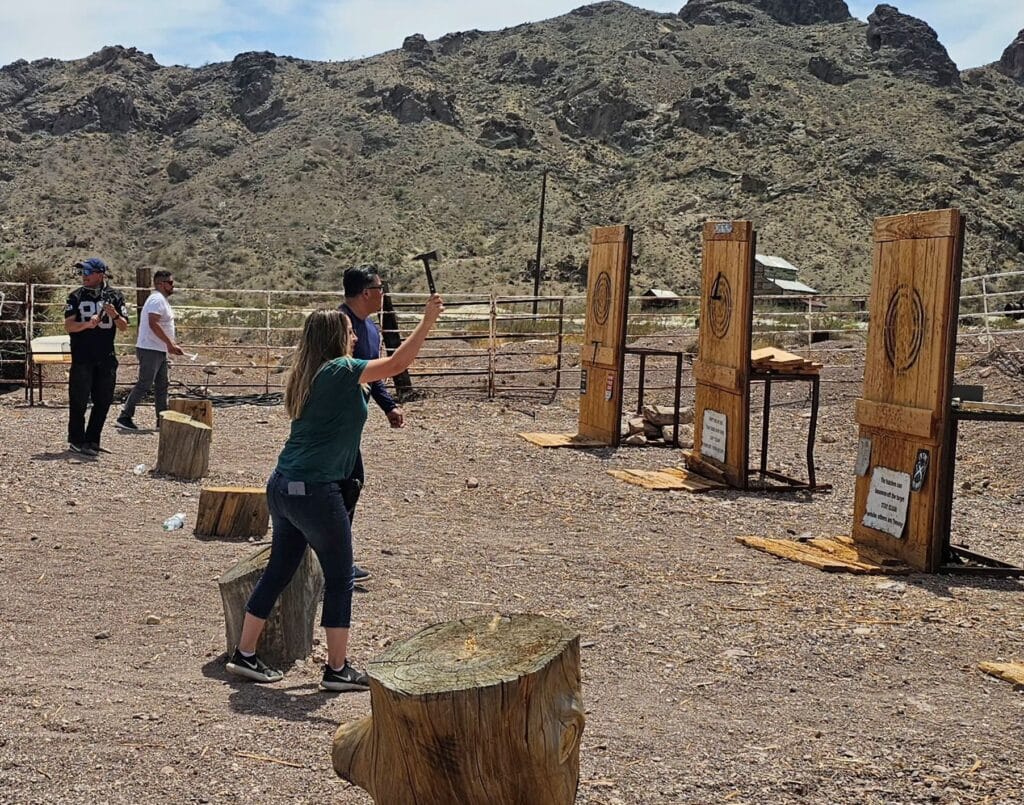 Axe-throwing in the Nevada desert with mountains, near Las Vegas Ghost Town ATV tours and RZR off-road adventures.