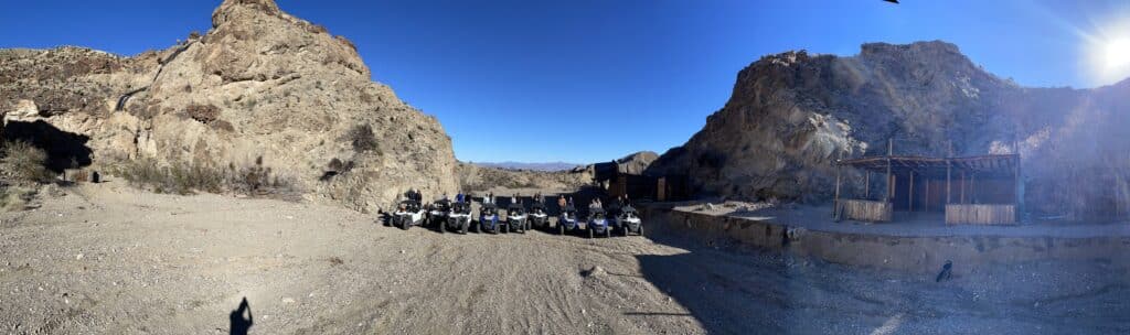 ATVs line rocky Nevada terrain near Las Vegas cliffs—ideal for ATV tours, RZR rides, and Colorado River adventures.