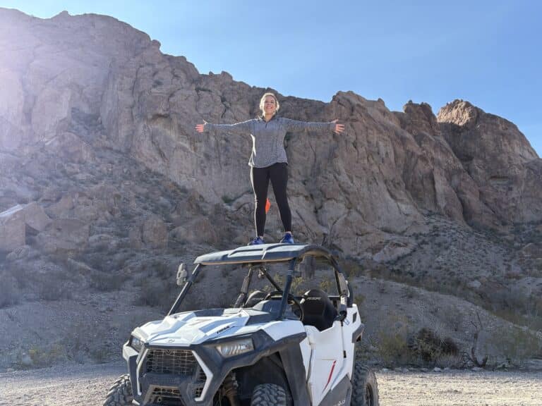 Adventurer atop an ATV near Nevada desert cliffs, perfect for RZR tours and Colorado River sightseeing close to Las Vegas.