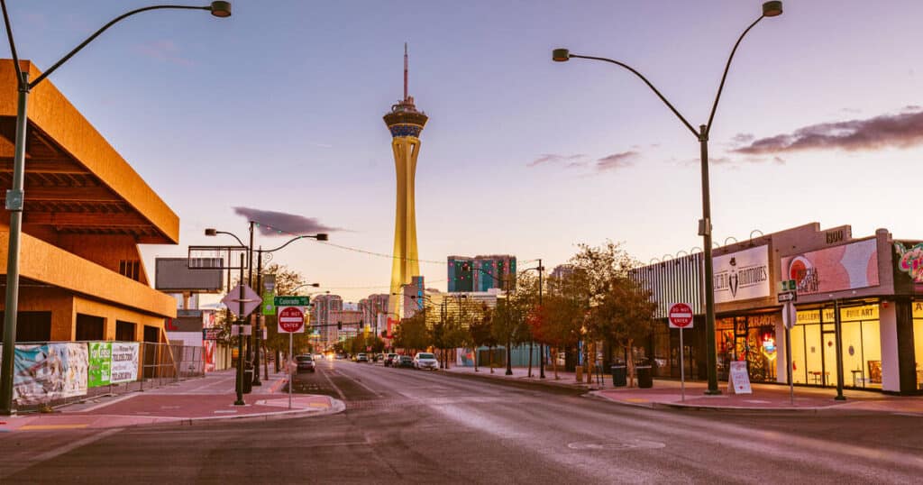 Las Vegas sunset street with Stratosphere Tower, glowing lights—great for Nevada ATV tours or Ghost Town sightseeing nearby.