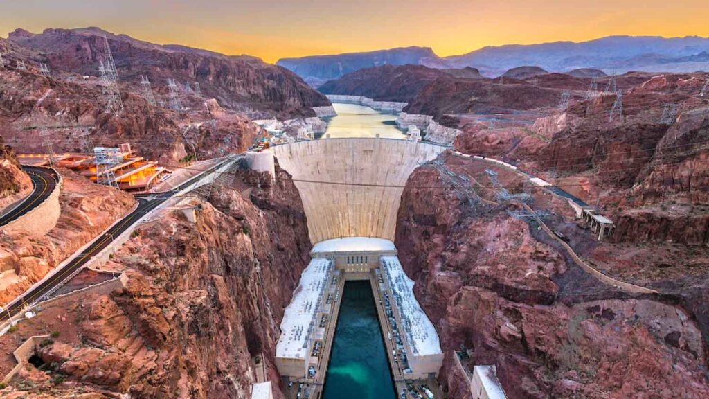 Sunset aerial of Hoover Dam, Nevada near Las Vegas, spanning the Colorado River; ideal for ATV tours or Ghost Town sightseeing.