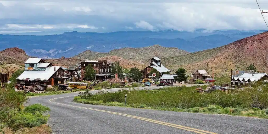 Rustic ghost town near Las Vegas, Nevada, with vintage cars and desert hills—ideal for ATV tours or Colorado River adventures.