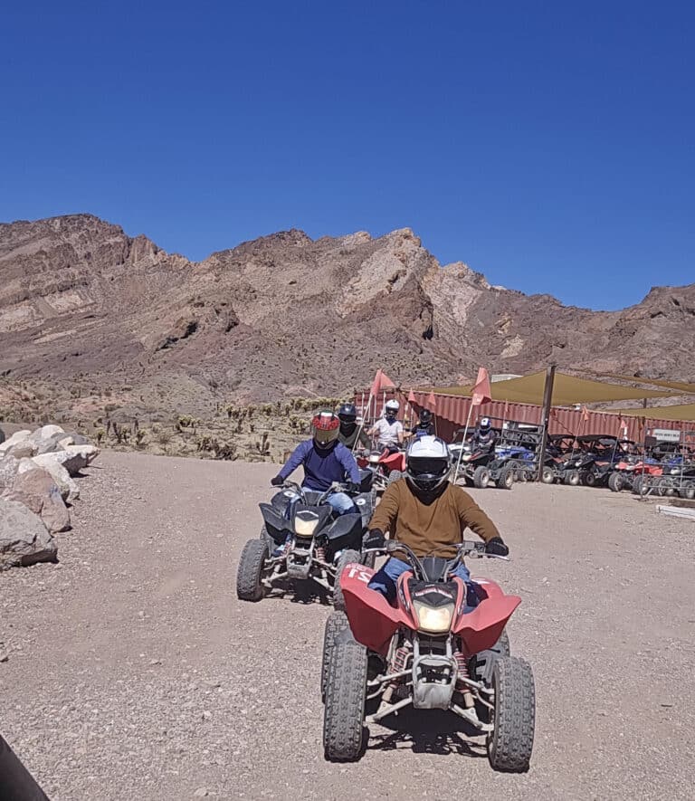 Group on ATV tours rides through a Nevada dirt trail near Las Vegas, exploring scenic landscapes and adventure routes.