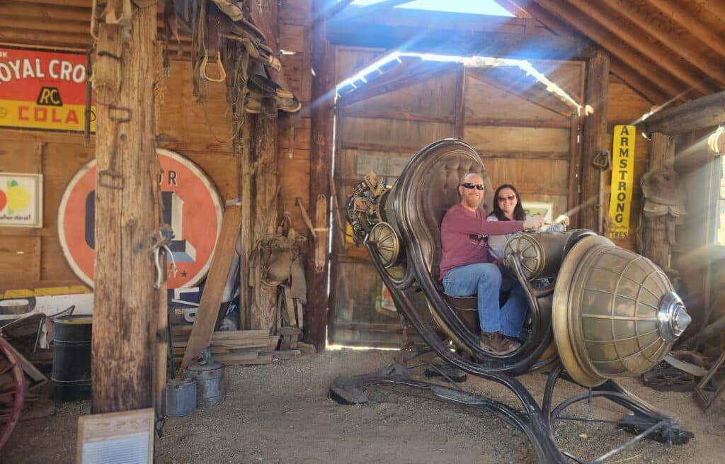 Explore a vintage time machine prop in a Nevada ghost town barn, perfect for sightseeing near Las Vegas and the Colorado River.