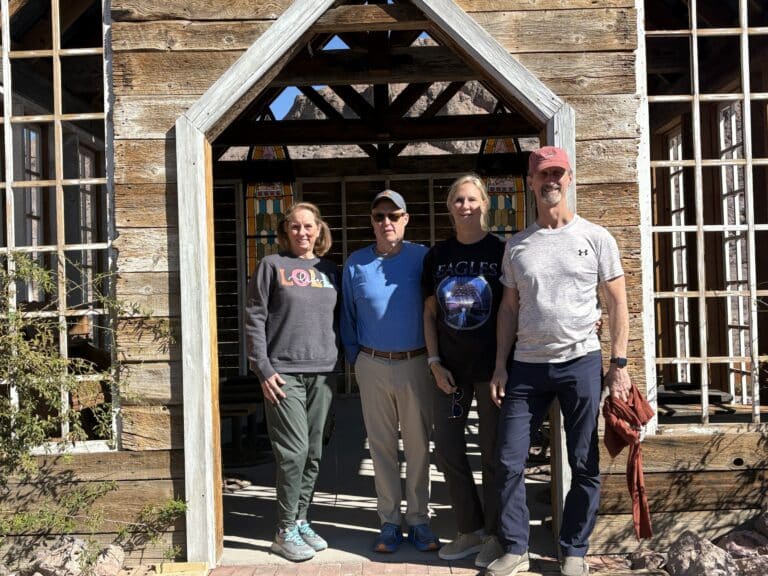 Visitors pose in front of a wooden building during a Las Vegas Ghost Town sightseeing tour near the Colorado River in Nevada.